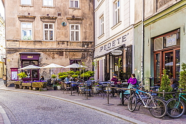 A cafe scene in the medieval old town, UNESCO World Heritage Site, in Krakow, Poland, Europe