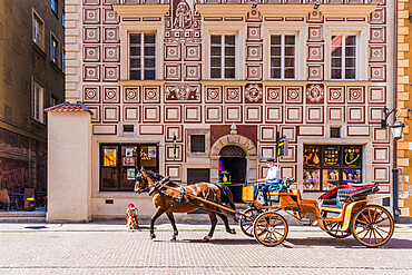 A horse drawn carriage passing beautiful architecture in the old town, UNESCO World Heritage Site, Warsaw, Poland, Europe