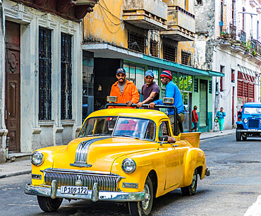 Local men riding in a vintage car, Havana, Cuba, West Indies, Caribbean, Central America