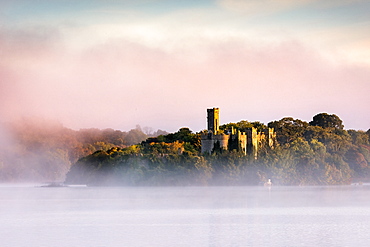 Mist at sunrise at McDermott's Castle on Lough Key or Castle Island in County Roscommon, Connacht, Republic of Ireland, Europe