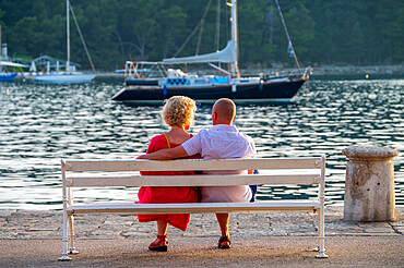 A couple sitting watching the sunset, Cavtat on the Adriatic Sea, Cavtat, Dubrovnik Riviera, Croatia, Europe