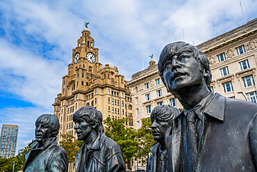 The bronze statue of The Beatles on the Liverpool Waterfront with Liver Building, Liverpool, Merseyside, England, United Kingdom, Europe