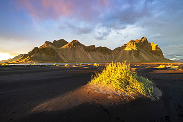 Dramatic light with view of the mountains of Vestrahorn from black volcanic sand beach at sunset, Stokksnes, South Iceland, Iceland, Polar Regions