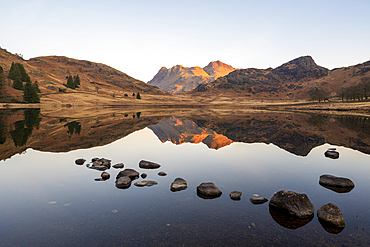 Sunrise light over Blea Tarn and the Langdale Pikes in spring, Lake District National Park Cumbria