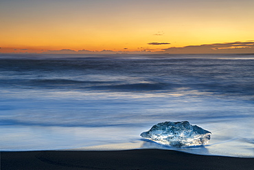 Single Ice formation at sunrise on ice beach at Jokulsarlon, Iceland, Polar Regions