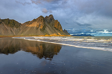 View of the mountains of Vestrahorn from black volcanic sand beach at sunset, Stokksnes, South Iceland, Iceland, Polar Regions