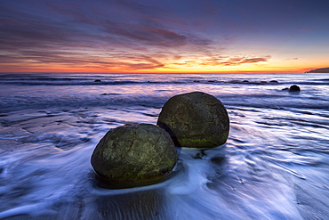 The Moeraki Boulders with dramatic sunrise at Moeraki Beach, Otago, South Island, New Zealand, Pacific