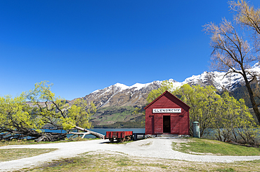 The red boat house in Glenorchy in spring, Queenstown Lakes district, Otago region, South Island, New Zealand, Pacific