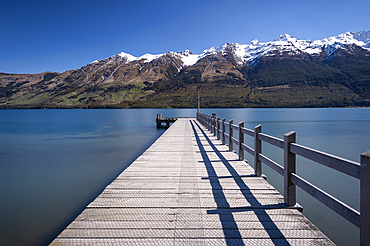 Wooden jetty leading into turquoise Lake Wakitipu, Queenstown, Otago, South Island, New Zealand, Pacific