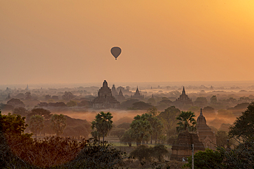 Hot air balloon flying over Stupas, Bagan (Pagan), Myanmar (Burma), Asia