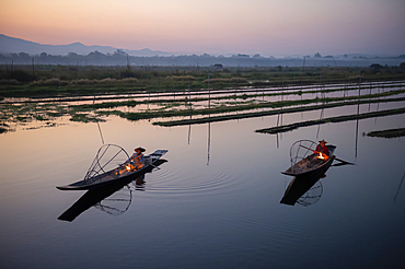 Two Intha leg rowing fisherman at Inle Lake gardens, Inle Lake, Shan State, Myanmar (Burma), Asia