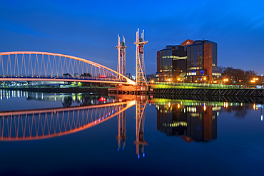 The Footbridge reflected in the River Irwell at night, Salford Quays, Manchester, England, United Kingdom, Europe