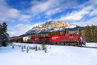 Canadian locomotive passing Castle Mountain in winter, near Banff, Alberta, Canadian Rockies, Canada, North America