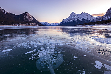 Snow capped mountains with methane bubbles at Lake Abraham, Kootenay Plains, Alberta, Canadian Rockies, Canada, North America