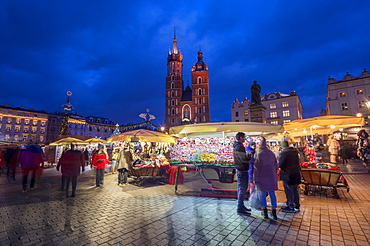 Christmas stalls at night with Saint Mary's Basilica, Market Square, UNESCO World Heritage Site, Krakow, Poland, Europe