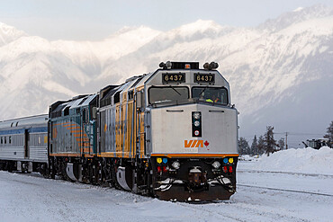 VIA Rail train with snow covered mountain backdrop, Jasper, Canadian Rocky Mountains, Alberta, Canada, North America