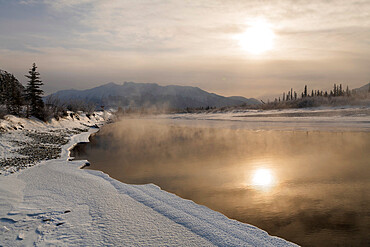 Reflected sun in Bow River in winter, Jasper, Canadian Rocky Mountains, Alberta, Canada, North America