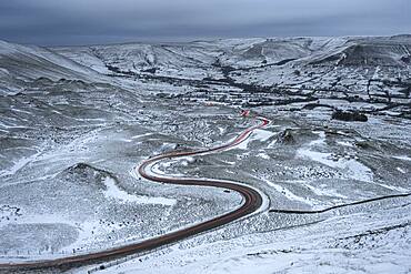 Car light trails on winding road in winter, Edale, Derbyshire, England, United Kingdom, Europe