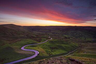 Spectacular sunset at Rushup Edge with winding road leading to Edale, Peak District, Derbyshire, England, United Kingdom, Europe