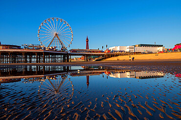 Blackpool beach with mirror reflections of the ferris wheel and Blackpool Tower, Blackpool, Lancashire, England, United Kingdom, Europe