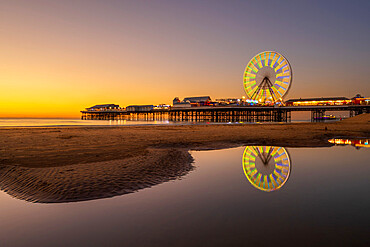 Big wheel and amusements on Central Pier at sunset, Blackpool, Lancashire, England, United Kingdom, Europe