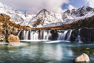 Cascades beneath the snow-covered Black Cuillin, Fairy Pools, Glen Brittle, Isle of Skye, Inner Hebrides, Highland, Scotland, United Kingdom, Europe