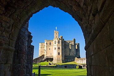 View through arch across lawns to the Great Tower of Warkworth Castle, Warkworth, Northumberland, England, United Kingdom, Europe