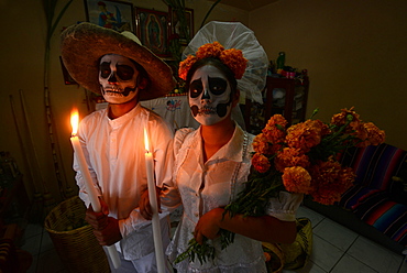 Couple depicting a wedding holding candles and marigolds during the Day of the Dead Celebration, Mitla, Oaxaca, Mexico, North America