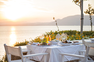 Food at a restaurant with a view over Pefkos Beach beach at sunset, Pefkos, Rhodes, Dodecanese, Greek Islands, Greece, Europe