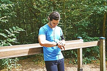 Man checking his connected bracelet.