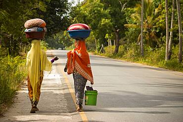 Women on a road in Zanzibar.