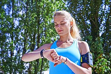 Woman checking her digital health tracker.