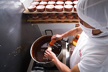 Waxing cheese at the Cheese Factory on the farm at Hacienda Zuleta, Imbabura, Ecuador, South America