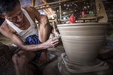 Portrait of a potter in an Oh Bo pottery shed, Twante, near Yangon, Myanmar, Burma