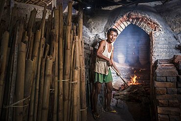 Portrait of a potter in an Oh Bo pottery shed, Twante, near Yangon, Myanmar, Burma