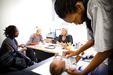 Reportage in a post-natal clinic in Champigny, France. Since leaving the neonatal unit, the twins (3-months old) are checked every week to follow their growth. Consultation with the post-natal clinic doctor.