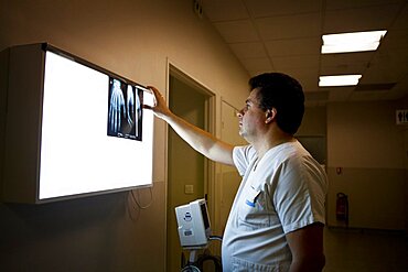 Reportage in A&E at Diaconesses Croix Saint Simon hospital in Paris, France. A doctor examining an x-ray of a hand.