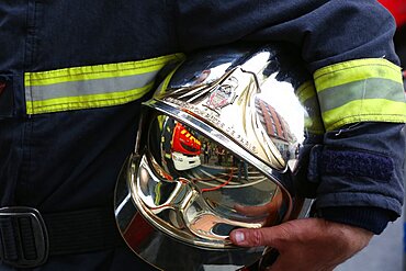 Firefighter carrying his helmet