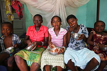 Children eating an african meal.