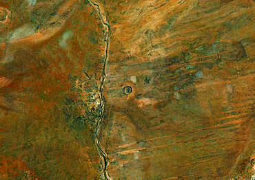 Wolf Creek Meteor Impact Crater, Australia, True Colour Satellite Image. True colour satellite image of Wolf Creek impact structure, Australia (age : 300 000 years ; diameter : 875 m). Image taken on 27 April 1990 using LANDSAT data.