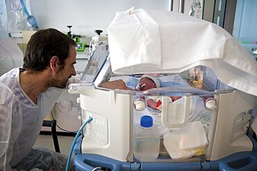 Father comforts Premature Baby