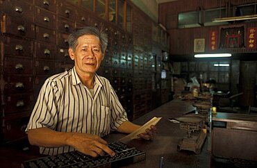 Vietnam, Pharmacist selling traditional Chinese malaria medicines