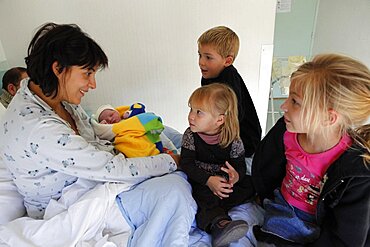 Children visiting mother and newborn in hospital