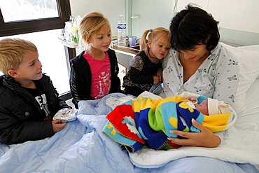 Children visiting mother and newborn in hospital