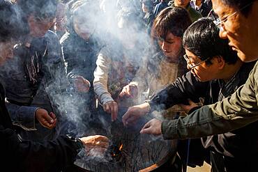 People burning incense, in Kiyomizu-dera temple, Kyoto. Kansai, Japan.