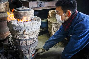 baking the outer mold, to resist the molten iron and make a iron teapot or tetsubin, nanbu tekki,Workshop of Koizumi family,craftsmen since 1659, Morioka, Iwate Prefecture, Japan