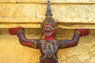 Statue of demon on a Golden Chedi,  at the temple of the Emerald Buddha Wat Phra Kaeo, Grand Palace, Bangkok, Thailand