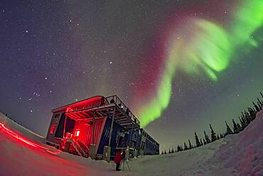 Orion and the winter sky, at left, and a swirl of colourful aurora over the Churchill Northern Studies Centre, in a display on February 11, 2018. People from the first Learning Vacations group of the season are shooting the Lights.