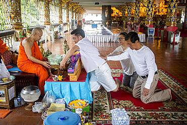 Donation to monks, Wat Suan Dok temple, Chiang Mai, Thailand