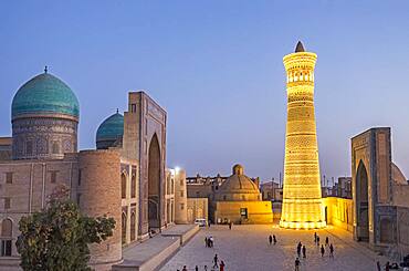 At right Kalon minaret and mosque. At left Mir-i-Arab medressa , Bukhara, Uzbekistan